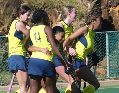 Azania Petersen smiles broadly as her teammates congratulate her on scoring the goal that won them their game against other Gauteng B. Photo: Brad Morgan.