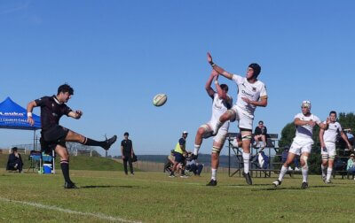 Clifton's Adam Selikow clears under pressure from two St Charles defenders at the Sharks Schools' Rugby Day. Photo: Brad Morgan.