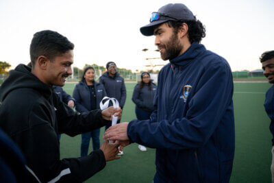 SACS coach Sam Holmes receiving his gold medal from SA hockey legend, Dayaan Cassiem. Photo: Enhanced Sports Media (ED MEDIA)