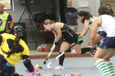 Codie Bestbier is challenged as she attempts to get a shot off in KZN Coastal A's 3-1 win over KZN Inland A on Wednesday morning at Thomas More College. Photo: Brad Morgan.